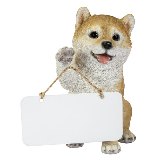 右手でボードを持つ柴犬